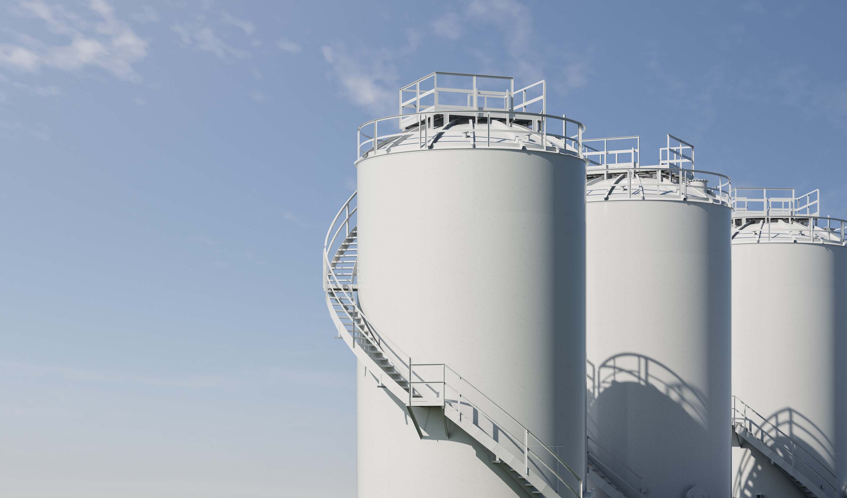 A digitally generated image of white storage tanks at petrochemical plant against blue sky